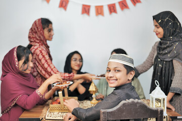 Fototapeta na wymiar Happy Indian Muslim family celebrating Eid Mubarak and Having Eid Feast at Home
