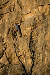 a person climber climbing a steep rock wall