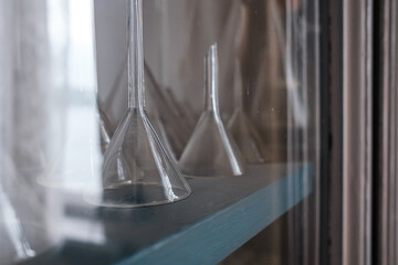 Funnel for a chemical laboratory on a cabinet shelf. 