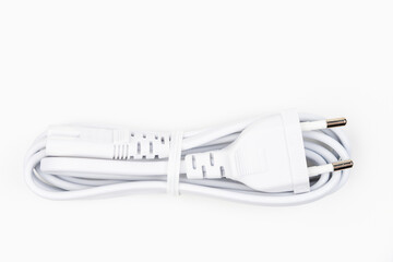 White cord with a plug from the charger on a light background with selective focus
