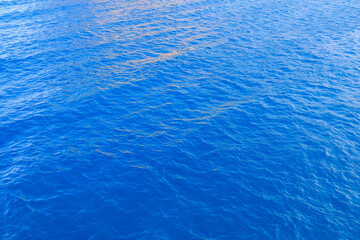 Very nice sea water background or backdrop with selective focus. Small waves of natural water surface texture.