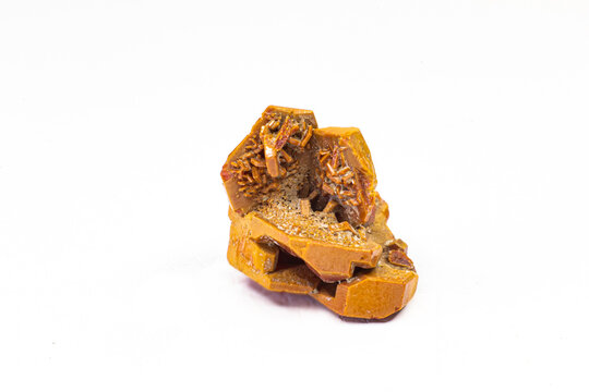 Close-up and focused beautiful and vibrant orange and red vanadinite crystal stone, uncut and raw with regular geometric-shaped crystal clusters isolated on a white background surface 