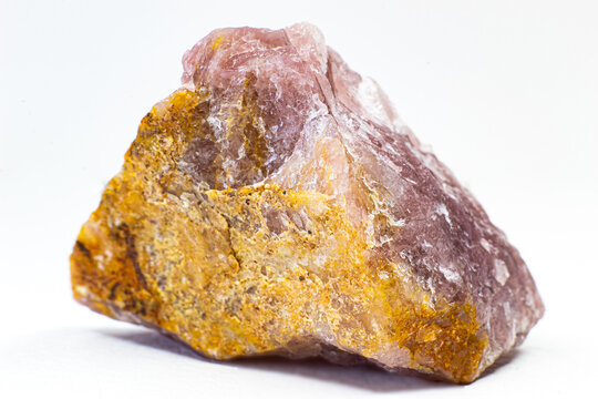 Close-up macro pink aventurine, strawberry quartz raw crystal stone, pink quartz with lepidolite mica inclusions isolated on a white background surface 