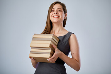 Smiling student holding pile of books or workbooks. Isolated advertising portrait.