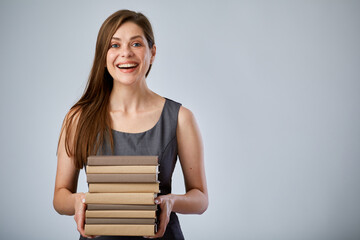 Smiling student holding pile of books or workbooks. Isolated advertising portrait.