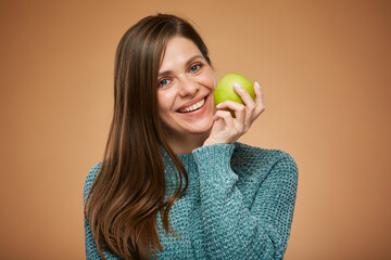 Woman with toothy smile holding green apple. Advertising isolated female portrait.