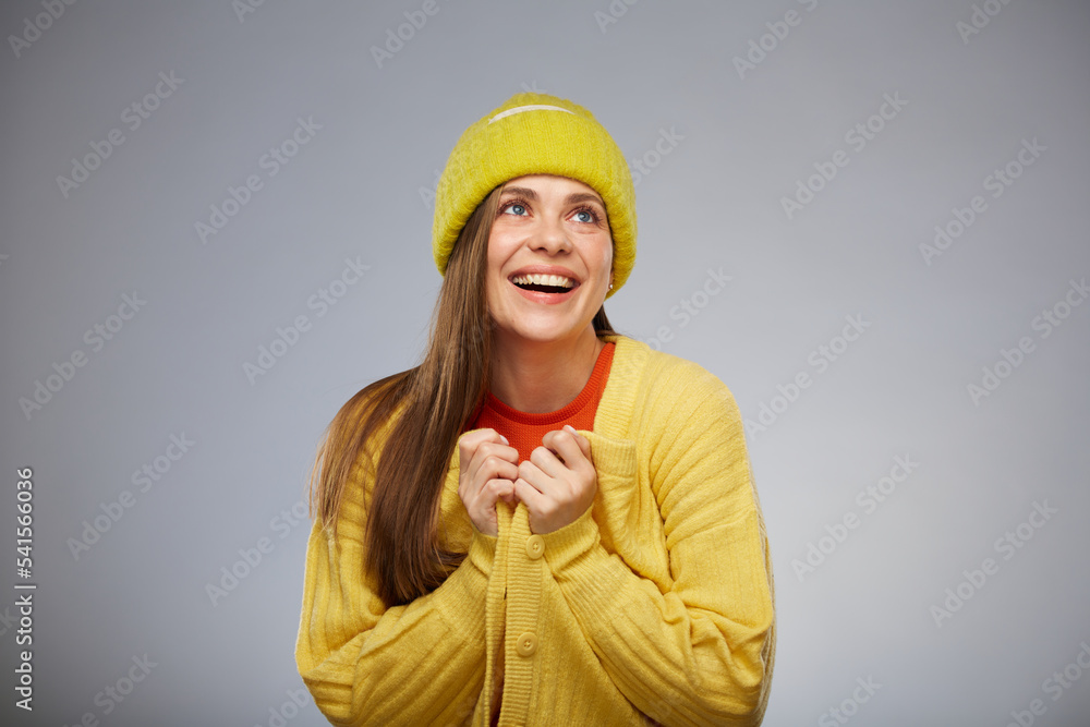 Wall mural Smiling woman in casual teenage style clothes looking up. Advertising female studio portrait.