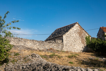 Beautiful, stone house with red clay roof and green window shutters in the oldest settlement on...