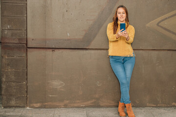 woman on the street looking at the mobile phone