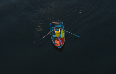 A man is rowing a boat