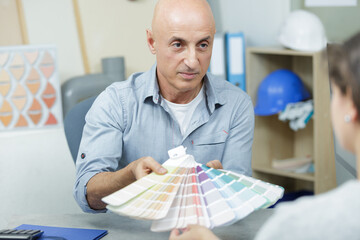 man showing color to female client