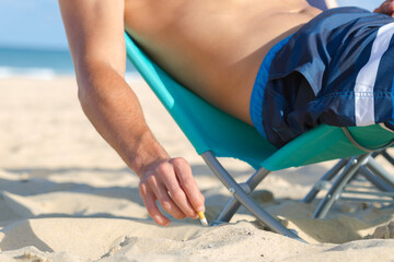 man is smoking at the beach