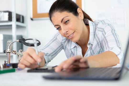 woman carrying out precision computer repair