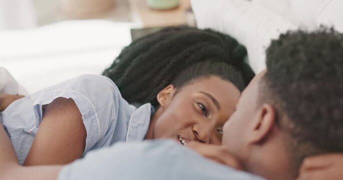 Morning, love and black couple relax in bed bonding, talking and cuddle together. Affection, relationship and loving black man and woman laughing, speaking and have conversation in bedroom on weekend