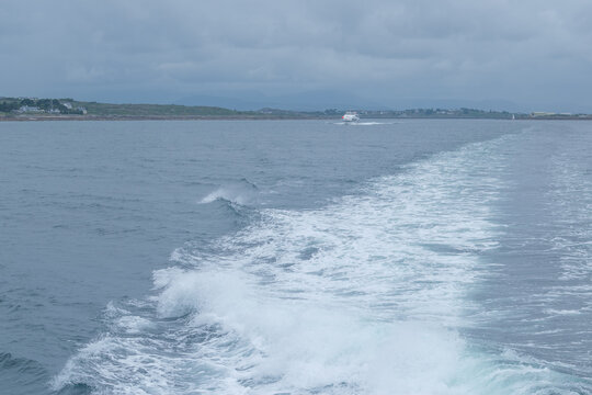 sea whirpool waves leftafter fast goig ship .