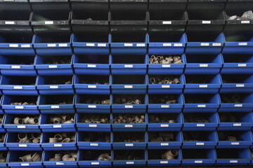 Fototapeta premium Shelf full of boxes, trays and dividers containing pipes and connections 