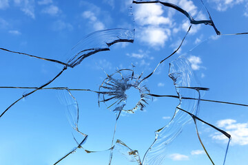 Broken glass window on blue sky background