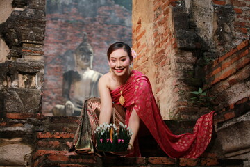 Asia Loy krathong tradition that paid respects to the water spirits, Beautiful woman dressed in...