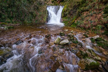 Beautiful shot of All Saints Waterfall flowing on rocks