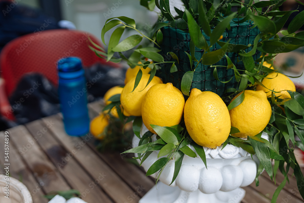 Wall mural wedding composition with green leaves and lemons