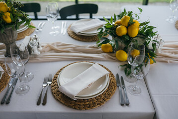Festive table at the wedding party decorated with lemon arrangements
