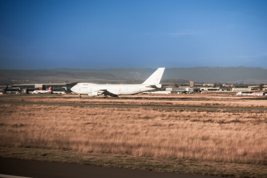 White plane on the runway in the desert