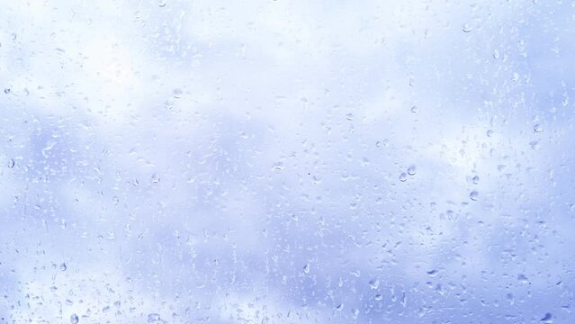 beautiful cloudscape in window, blue texture of glass background with water drops, place for text, horizontal banner with blurry bokeh, nature protection, Severe Weather