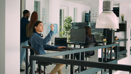 Digital developer analyzing ar hologram to work on html script, using holographic database interface with augmented reality. Cloud computing program with terminal window in office.