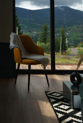 Modern yellow dining chair in modern interior with mountain view