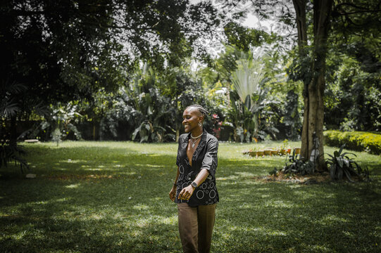 a woman happily walking in a garden