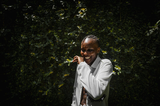 a black woman laughing in a garden