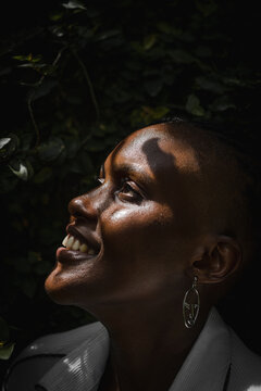 Closeup of black woman smiling in garden 