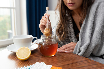 Sick woman drinks tea with honey