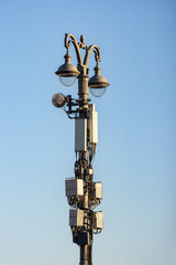 Fototapeta na wymiar Telecommunication cellular equipment on the street light lamp pole 