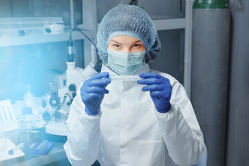 Scientist or nurse holding a test tube in a medical research laboratory