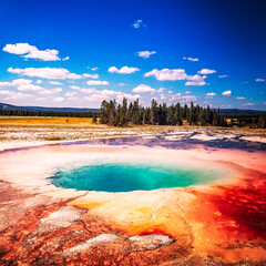 Hot spring in Yellowstone National Park in summer with blue sky