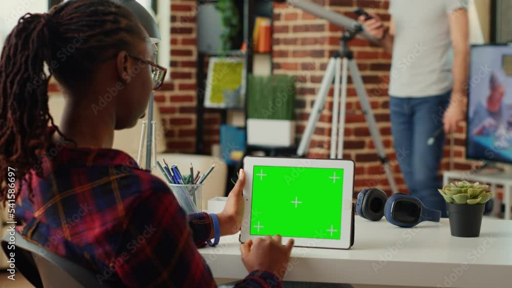 Poster african american adult using portable tablet with horizontal greenscreen on display, analyzing blank