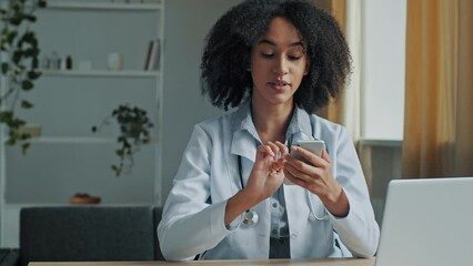 African doctor woman therapist use mobile phone app texting message medical recommendation for patient consultation online distance treatment medicine in pandemic time modern technology and healthcare - Powered by Adobe