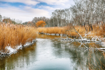 Winter landscape by a river in the sunset.