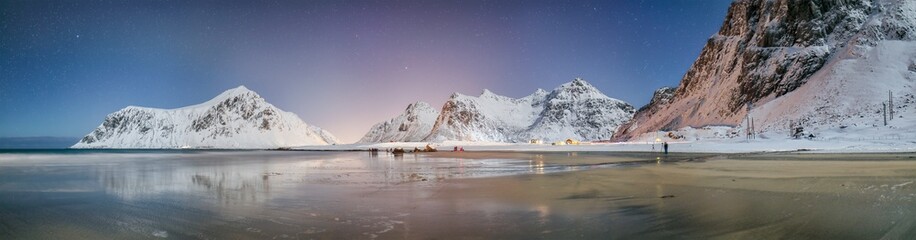 Fabulous winter scenery on Skagsanden beach at night with starry sky.
