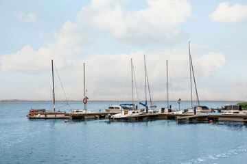 Fototapeta na wymiar Pier with moored boats in sea for rent outdoors