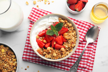 Flat lay composition with tasty granola and ingredients served on white table. Healthy meal