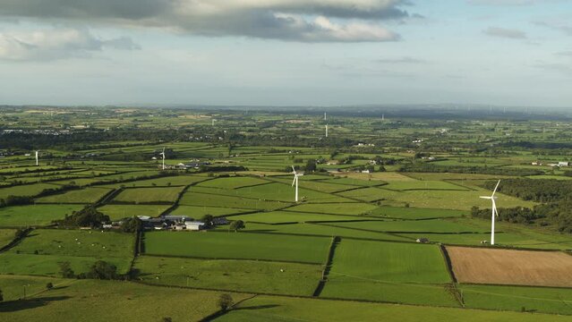 Aerial flyover view of wind turbines in rolling landscape / Crossgare, Londonderry, Northern Ireland