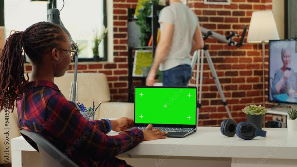 Aufkleber african american woman working with greenscreen display on laptop, using blank copy space background