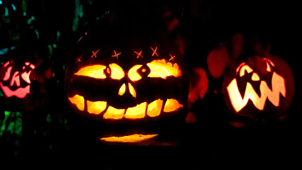 Carved Jack-o-lanterns lit at night for Halloween	