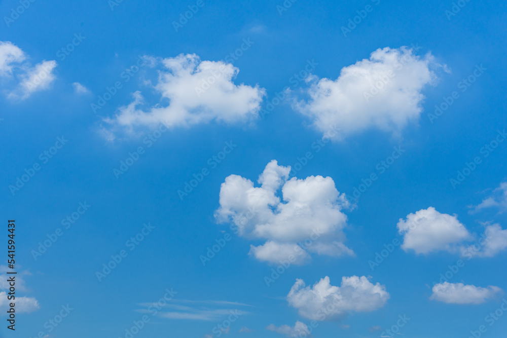 Wall mural Blue sky background with white clouds