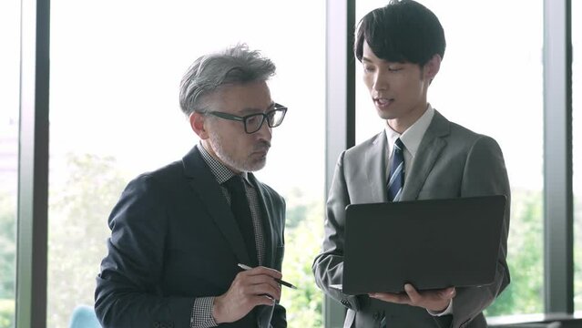 事務所で打ち合わせをするビジネスマン
