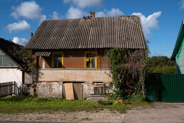 Abandoned empty traditional Russian wooden village house on a sunny summer day, Izborsk, Pskov region, Russia