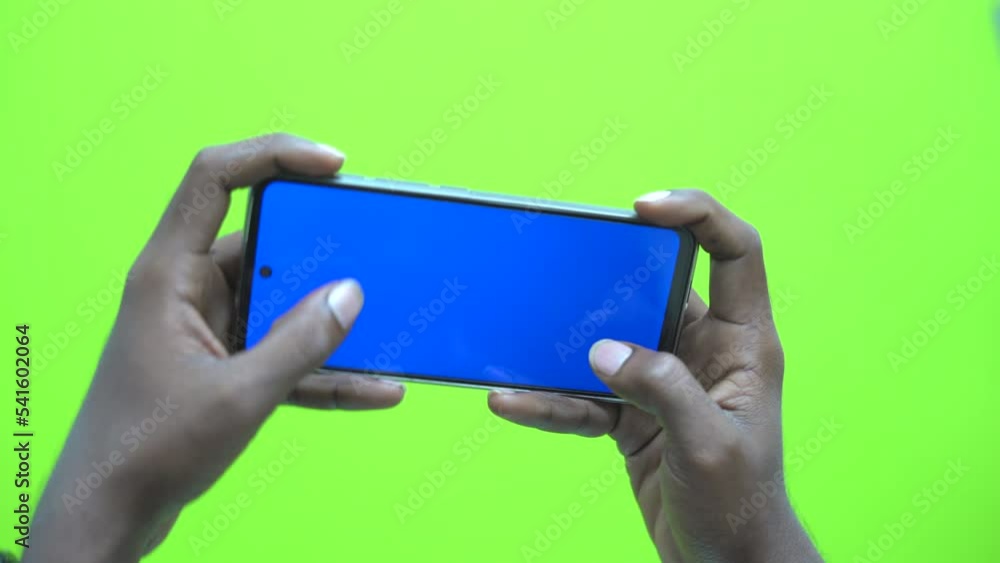Poster playing game on mobile in background croma