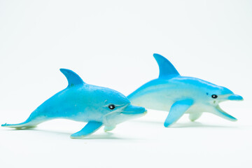 Plastic Toy Dolphins on white background